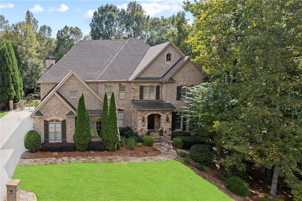 a aerial view of a house with a yard potted plants and a tree