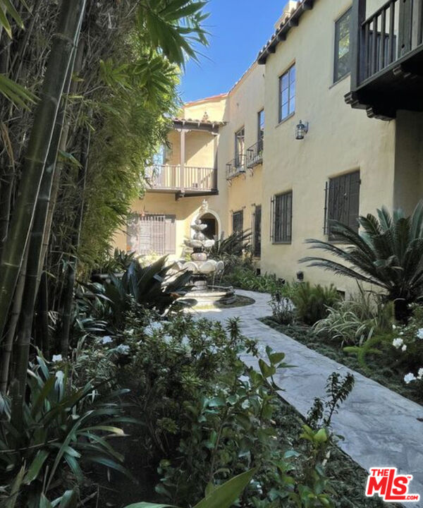 a view of a house with a backyard and garden