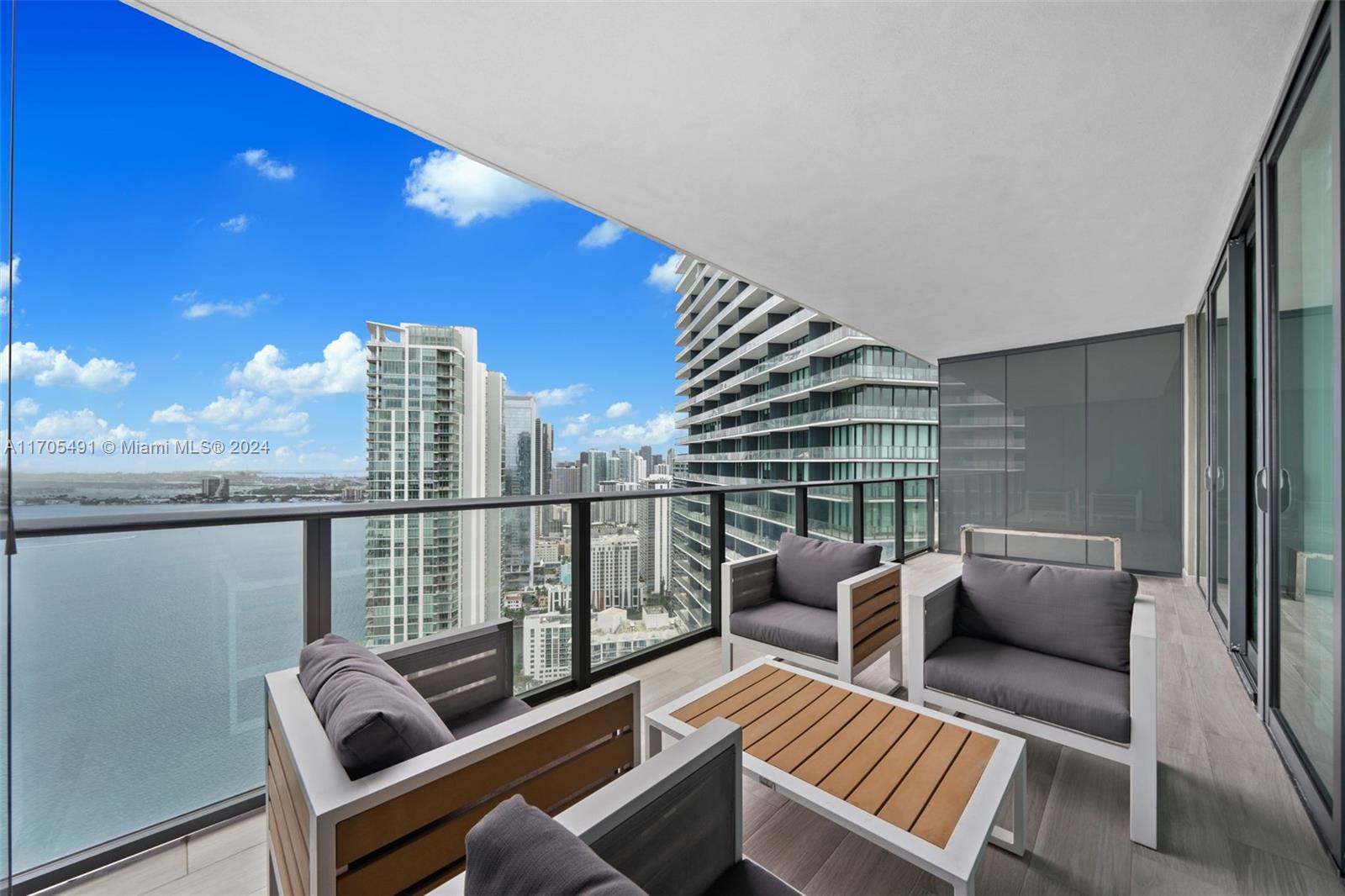 a view of balcony with couch and chairs