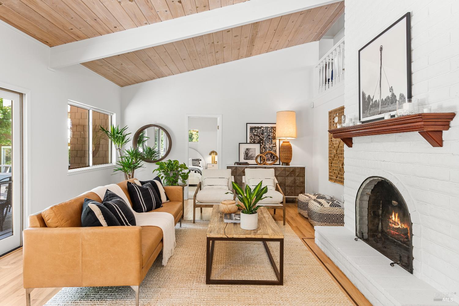 a living room with furniture a fireplace and a large window