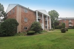 a view of a house with backyard and garden