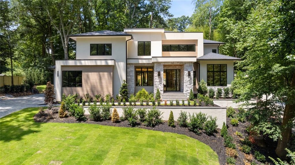 a view of a house with swimming pool and garden