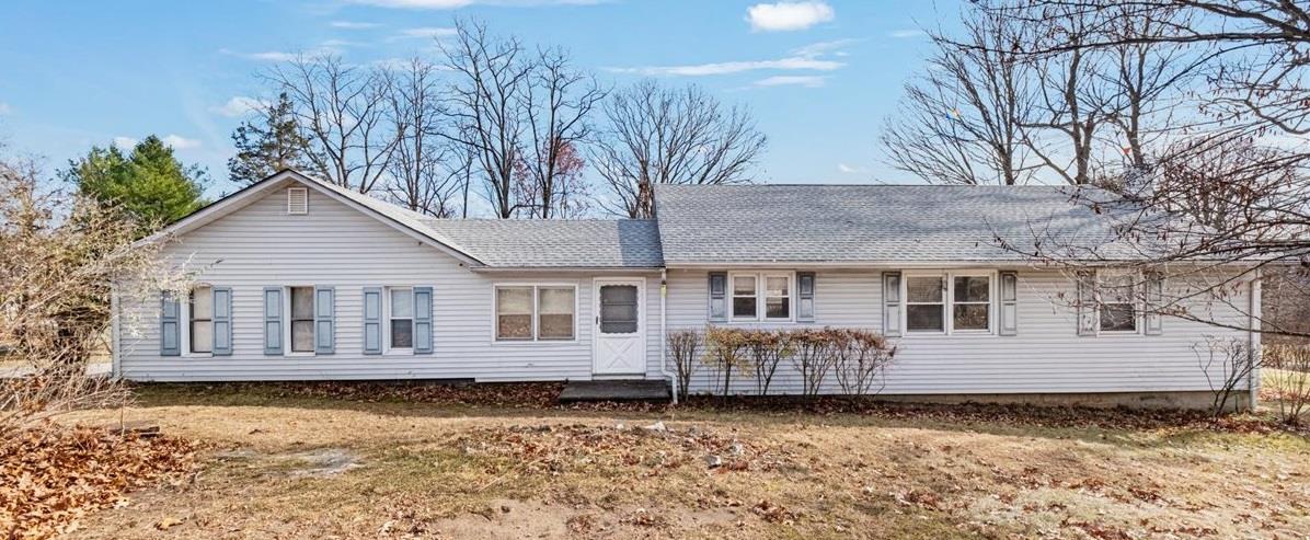 Rear view of house featuring a yard