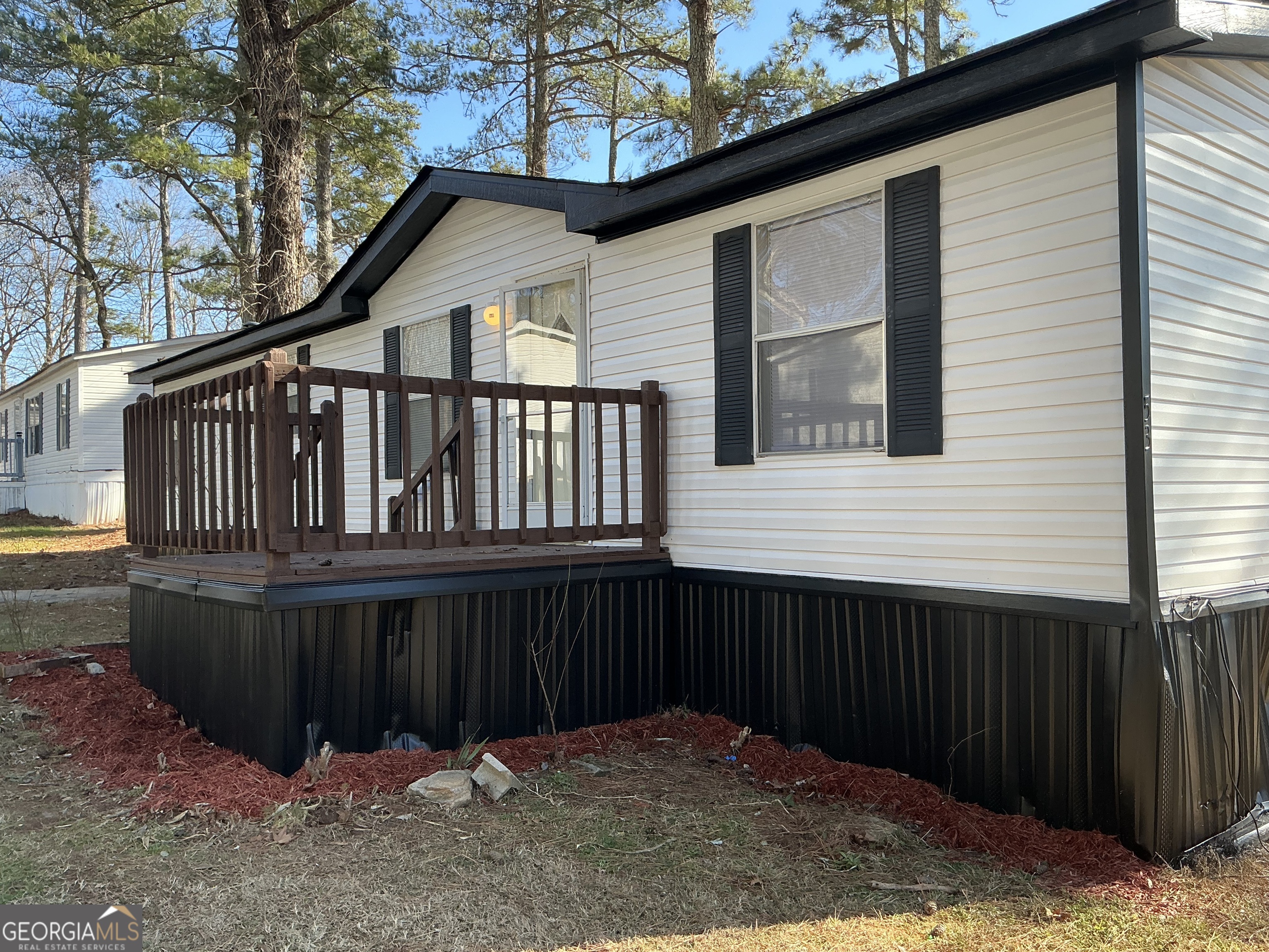 a view of wooden house with a wooden fence