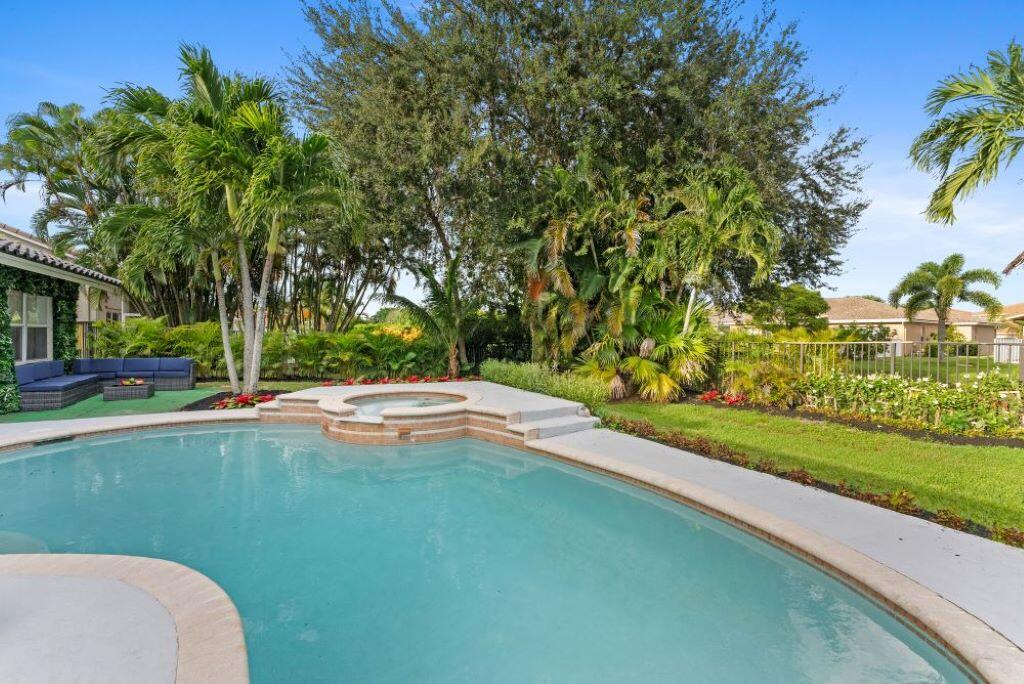 a view of a swimming pool and trees in the background