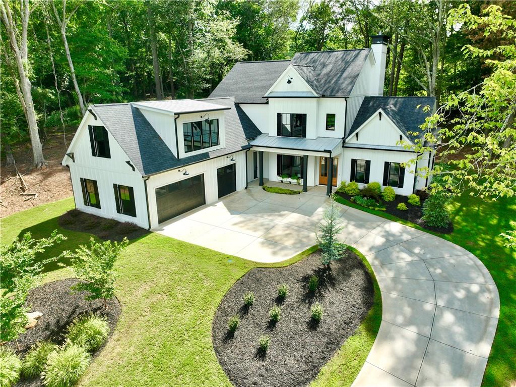 an aerial view of a house with a yard and large trees