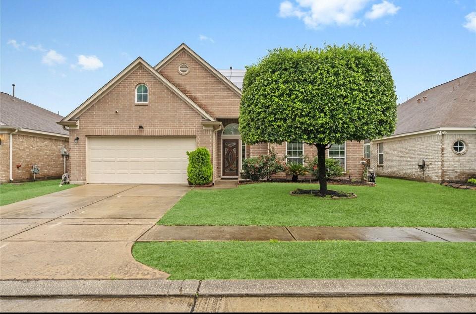 a front view of a house with a yard and garage