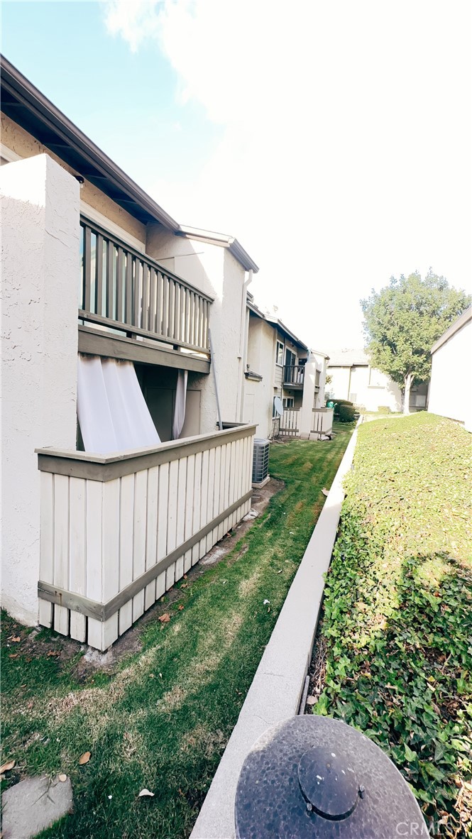 a view of backyard with deck and garden