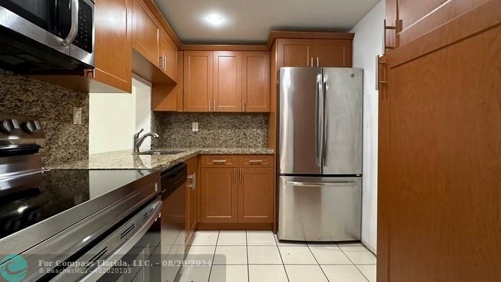 a kitchen with a refrigerator and a sink