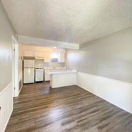 a view of a kitchen with wooden floor