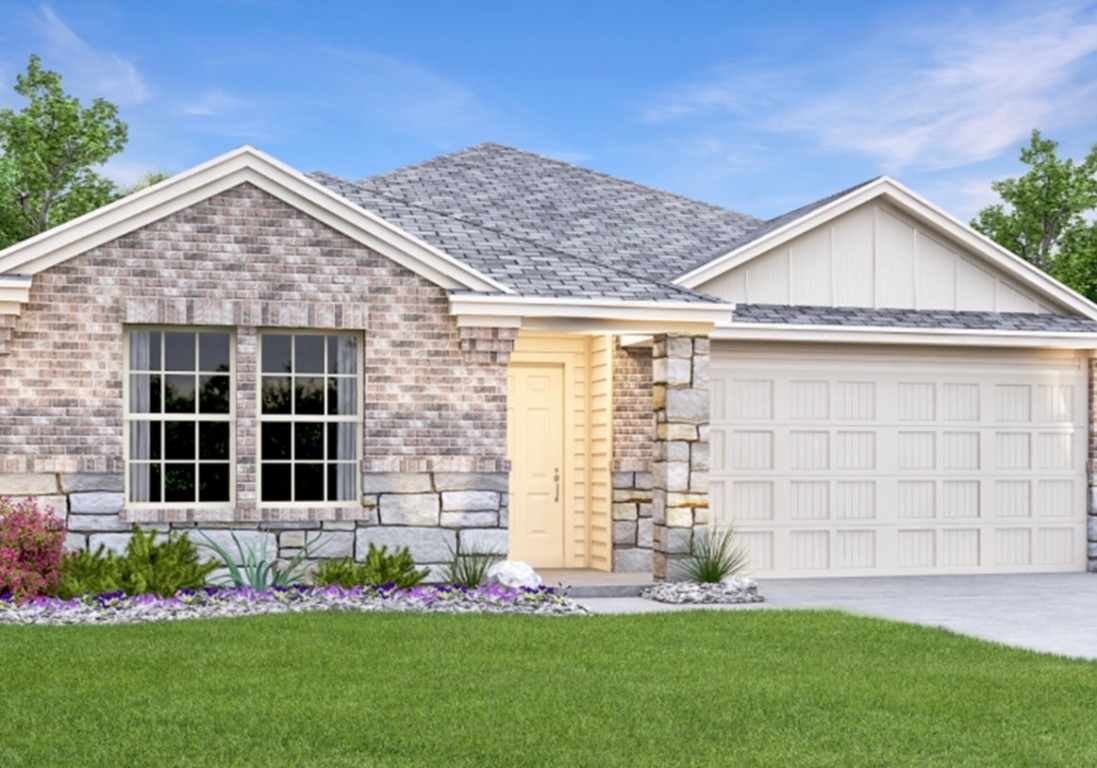 a front view of a house with a garden and yard