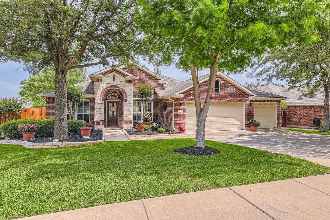 a front view of a house with a garden and yard