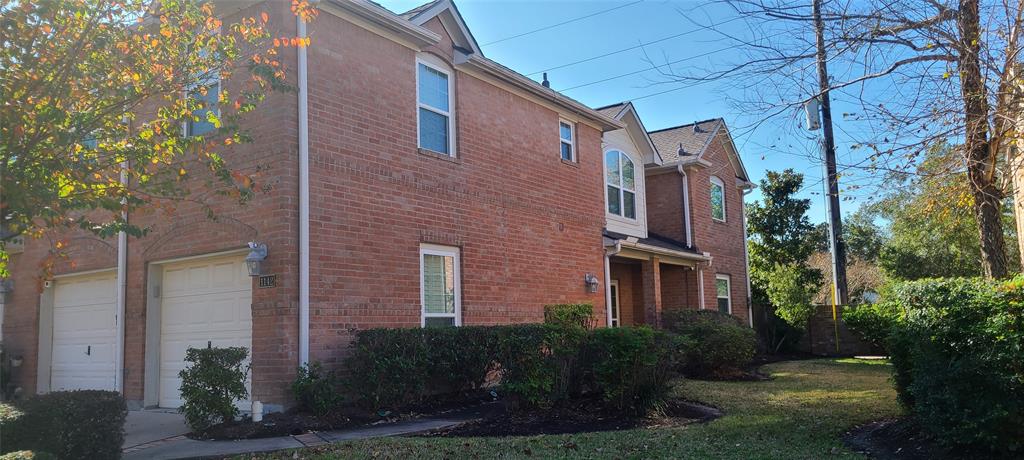 a view of a brick building next to a yard