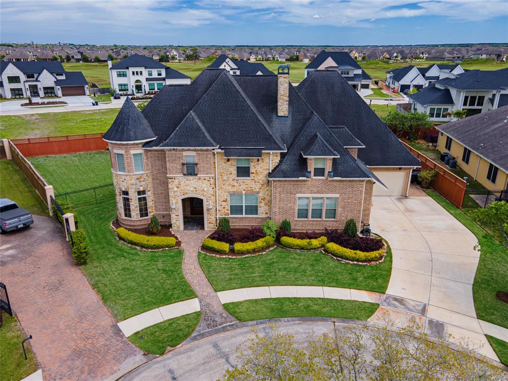 an aerial view of a house with swimming pool and patio