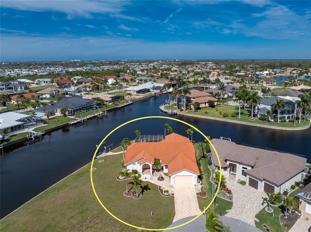 an aerial view of a house with a swimming pool and outdoor seating