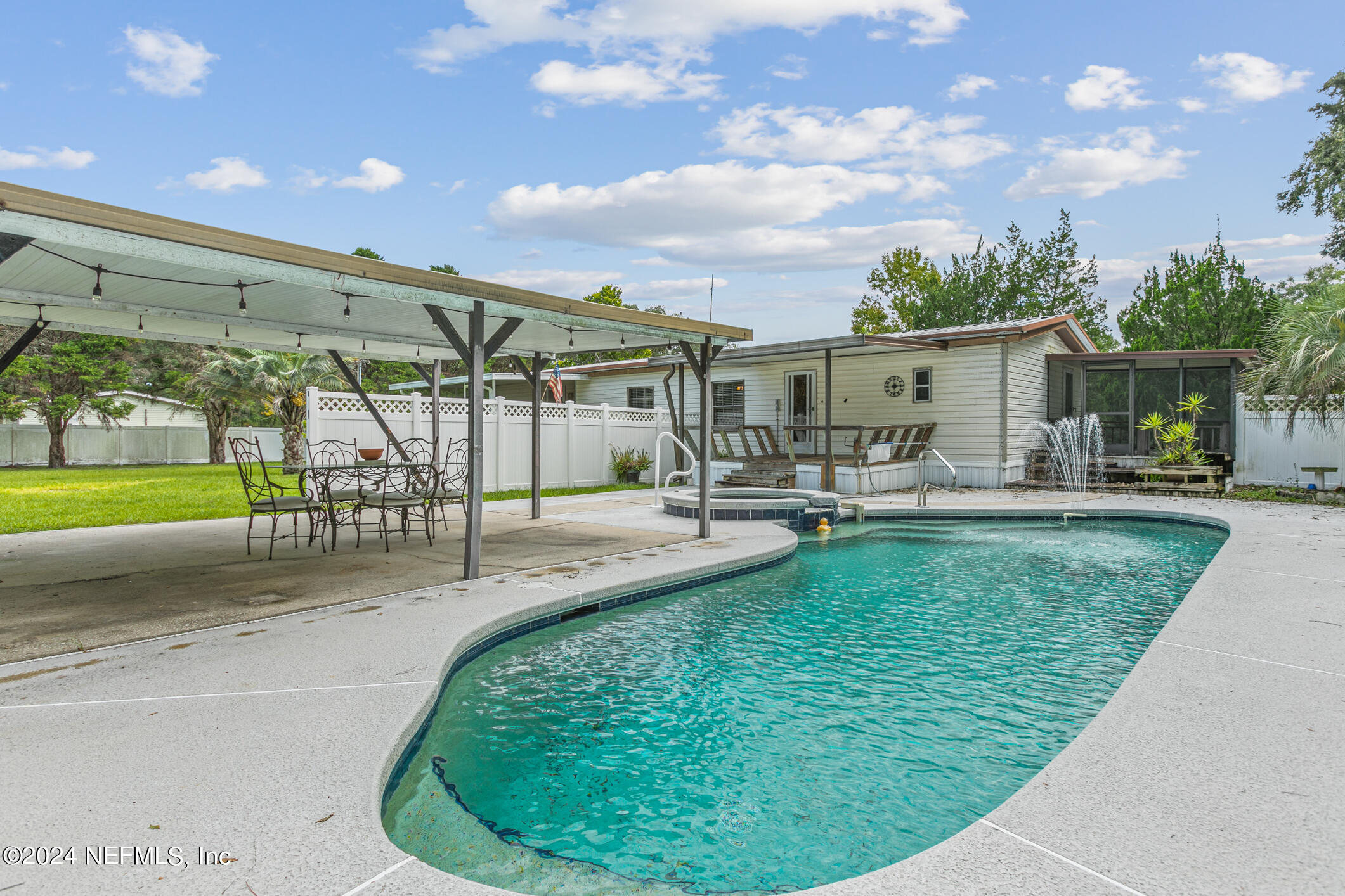 a swimming pool with outdoor seating and yard