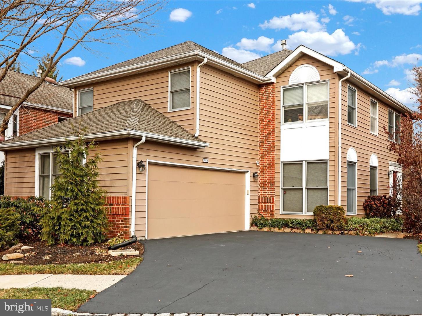 a view of a house with a yard and garage