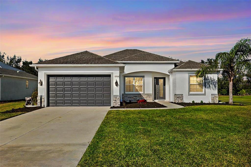 a front view of a house with a yard and garage