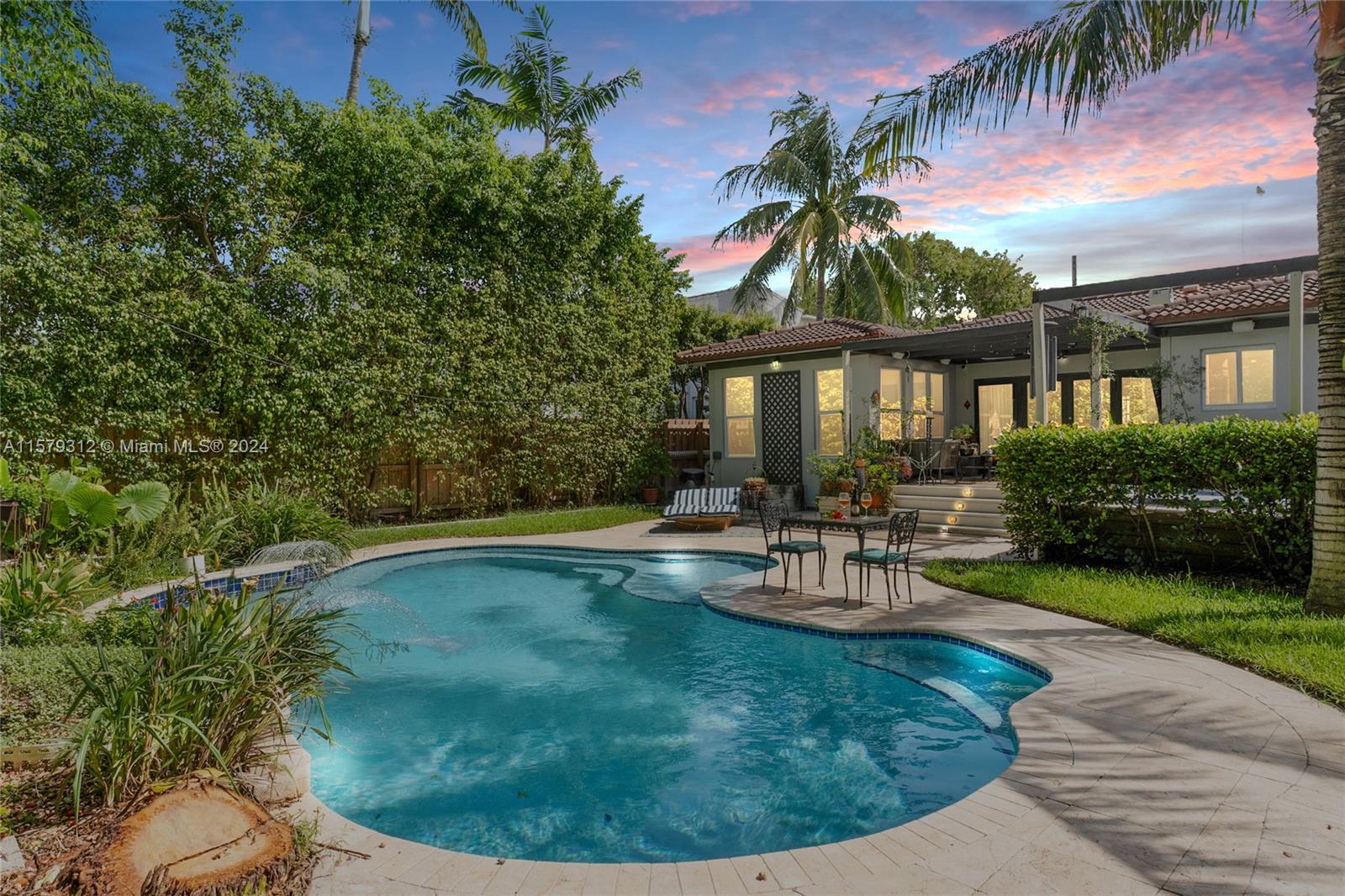 a view of a house with swimming pool and sitting area