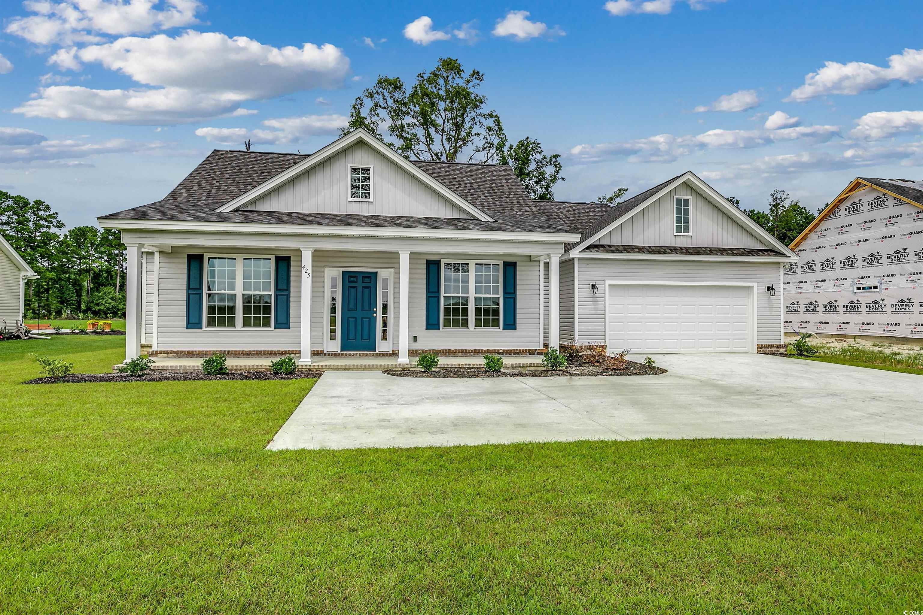 Ranch-style house featuring a garage and a front l