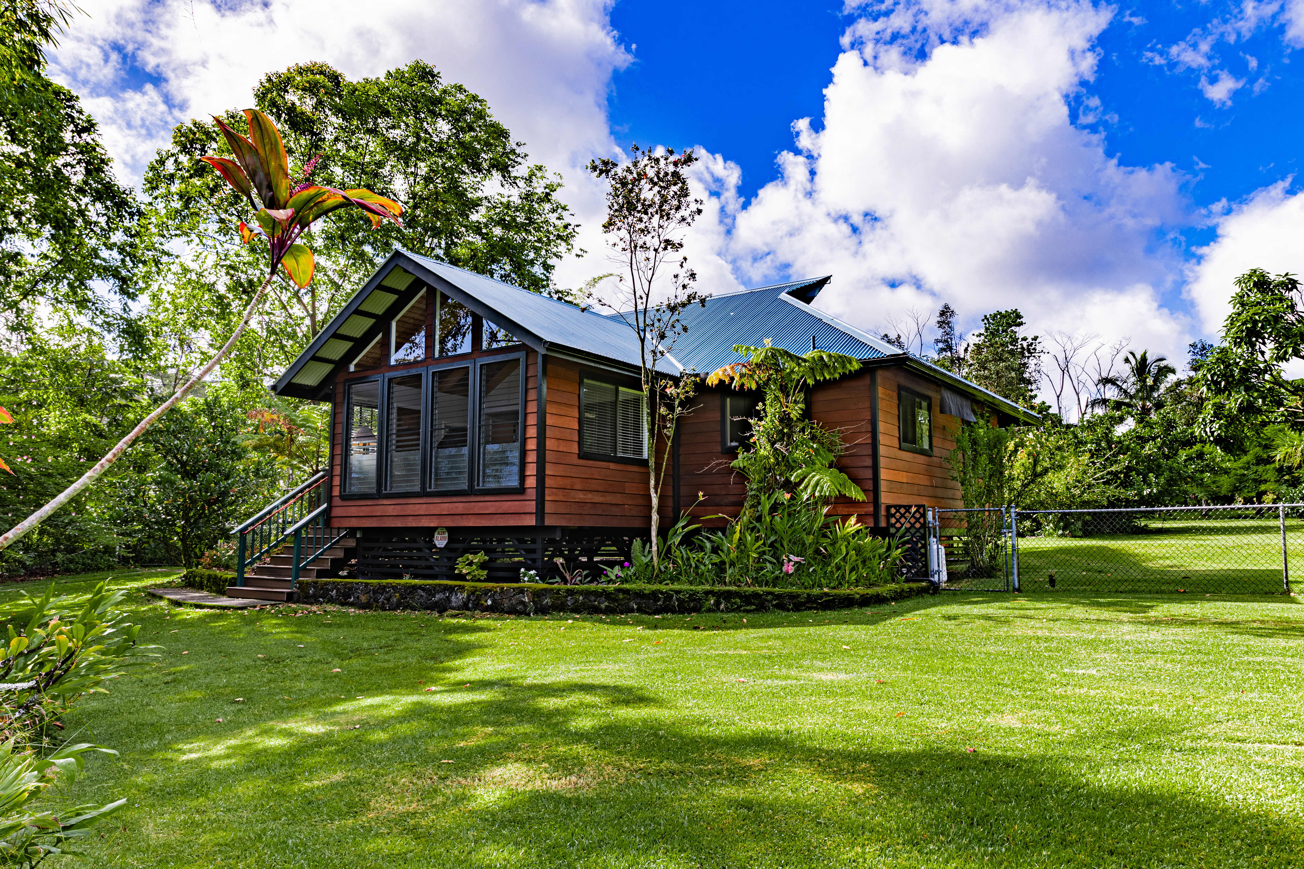 a front view of a house with a garden