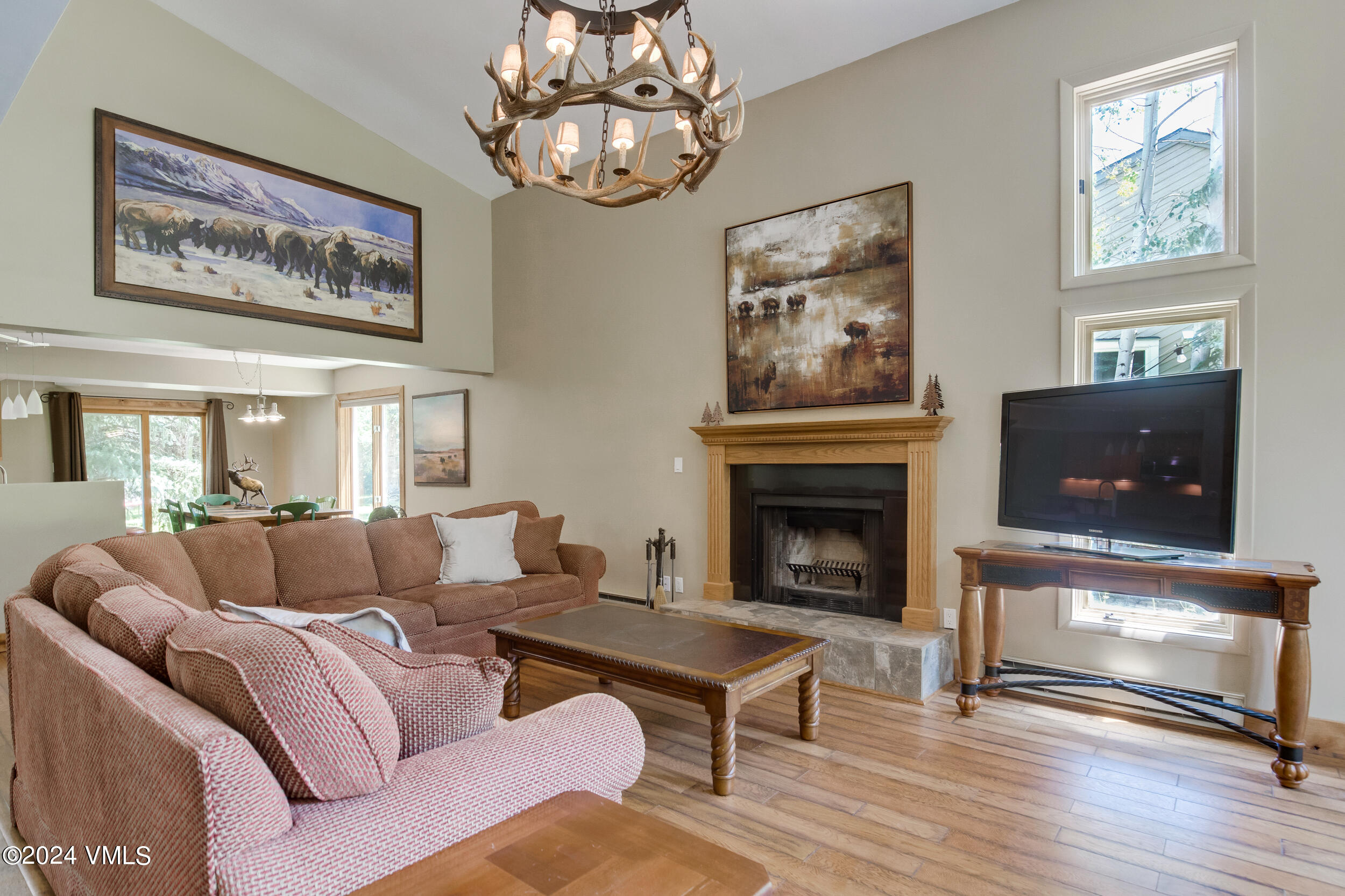 a living room with furniture a fireplace and a flat screen tv