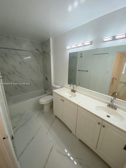 a bathroom with a double vanity sink toilet and shower