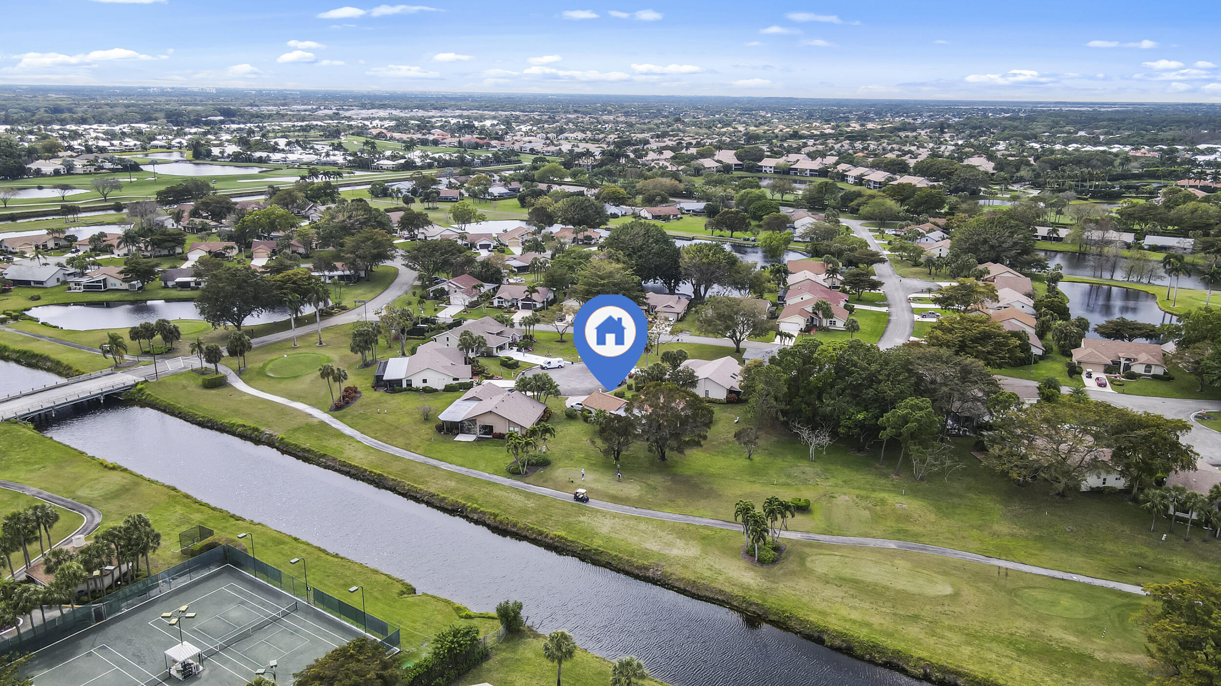 an aerial view of a city with lots of residential buildings ocean and mountain view in back