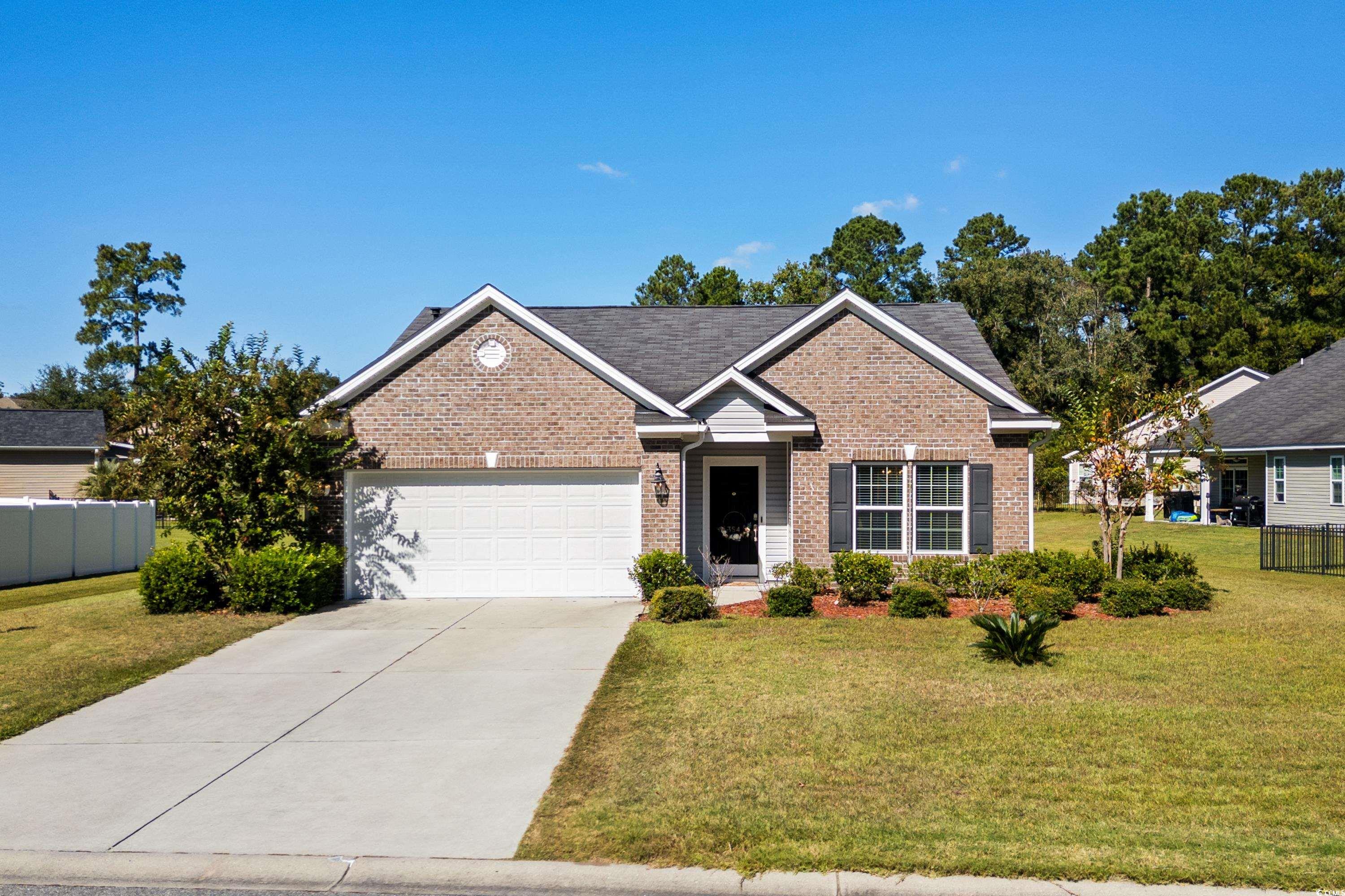 View of front of house with a front lawn and a gar