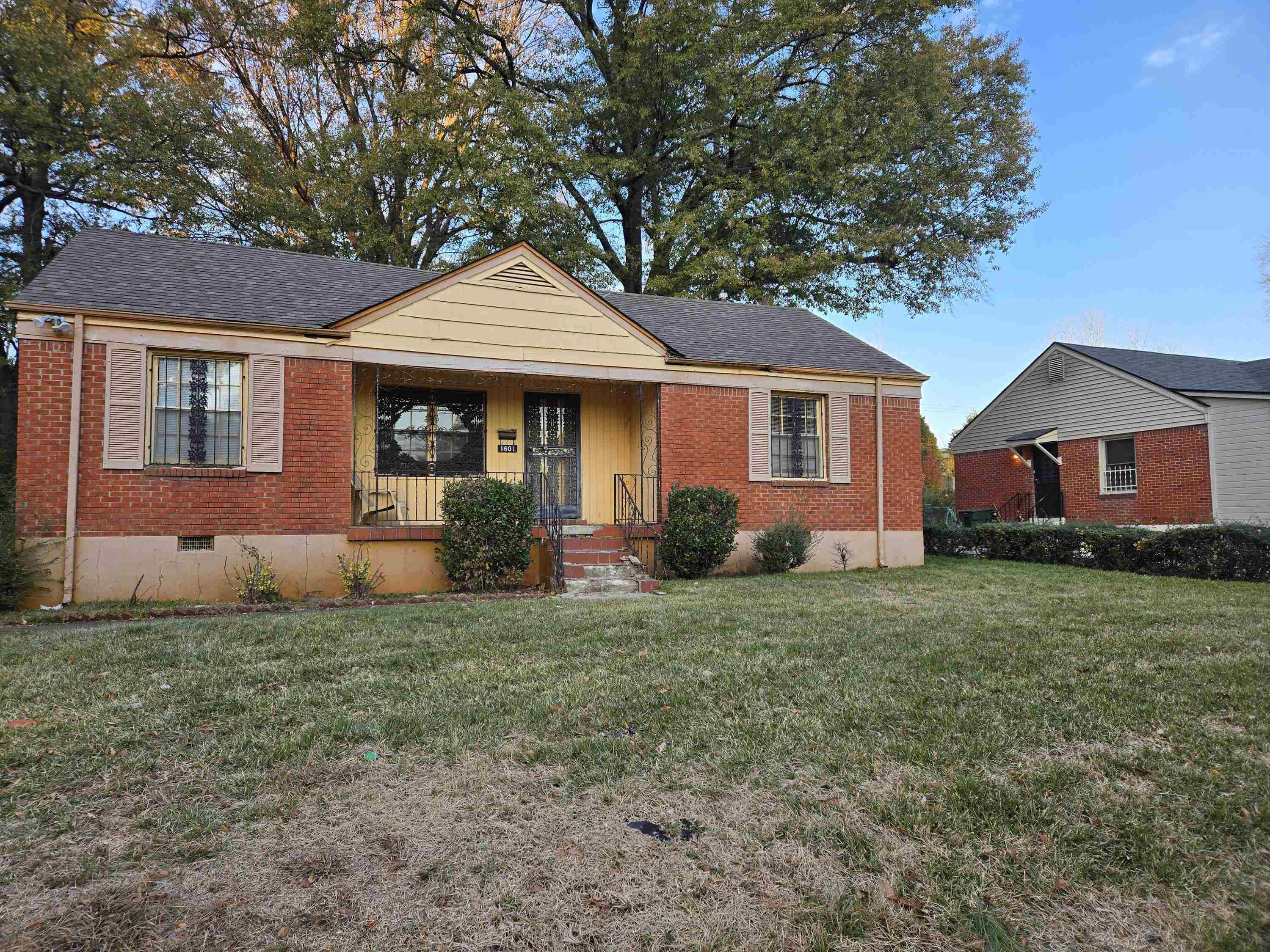 View of front of property featuring a front yard and a porch