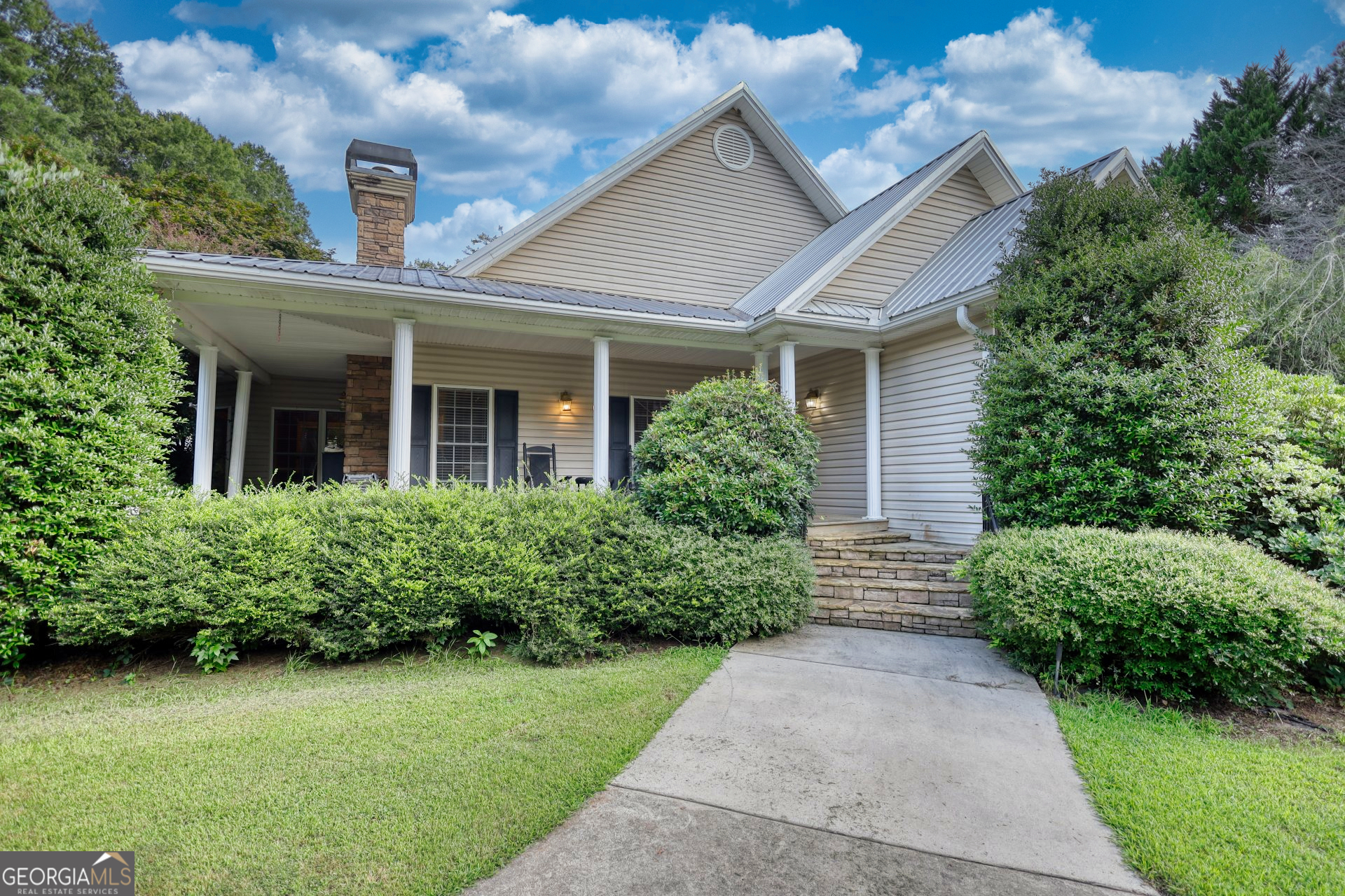 a front view of a house with garden