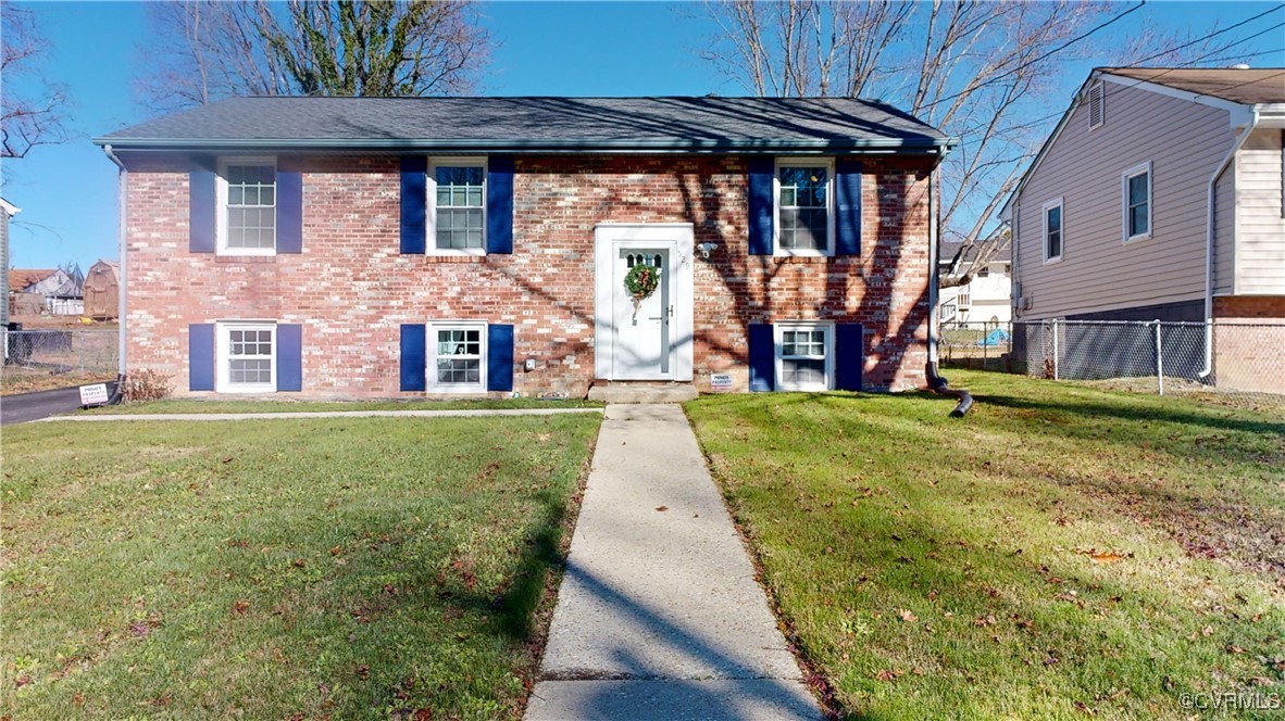 a view of a brick house with a yard