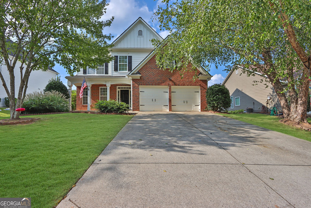 a front view of house with yard and green space