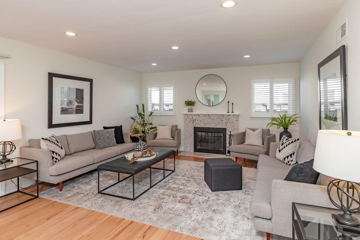 a living room with furniture a window and a fireplace