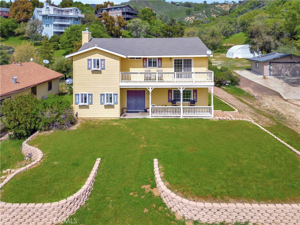 a view of a house with a yard balcony and sitting area