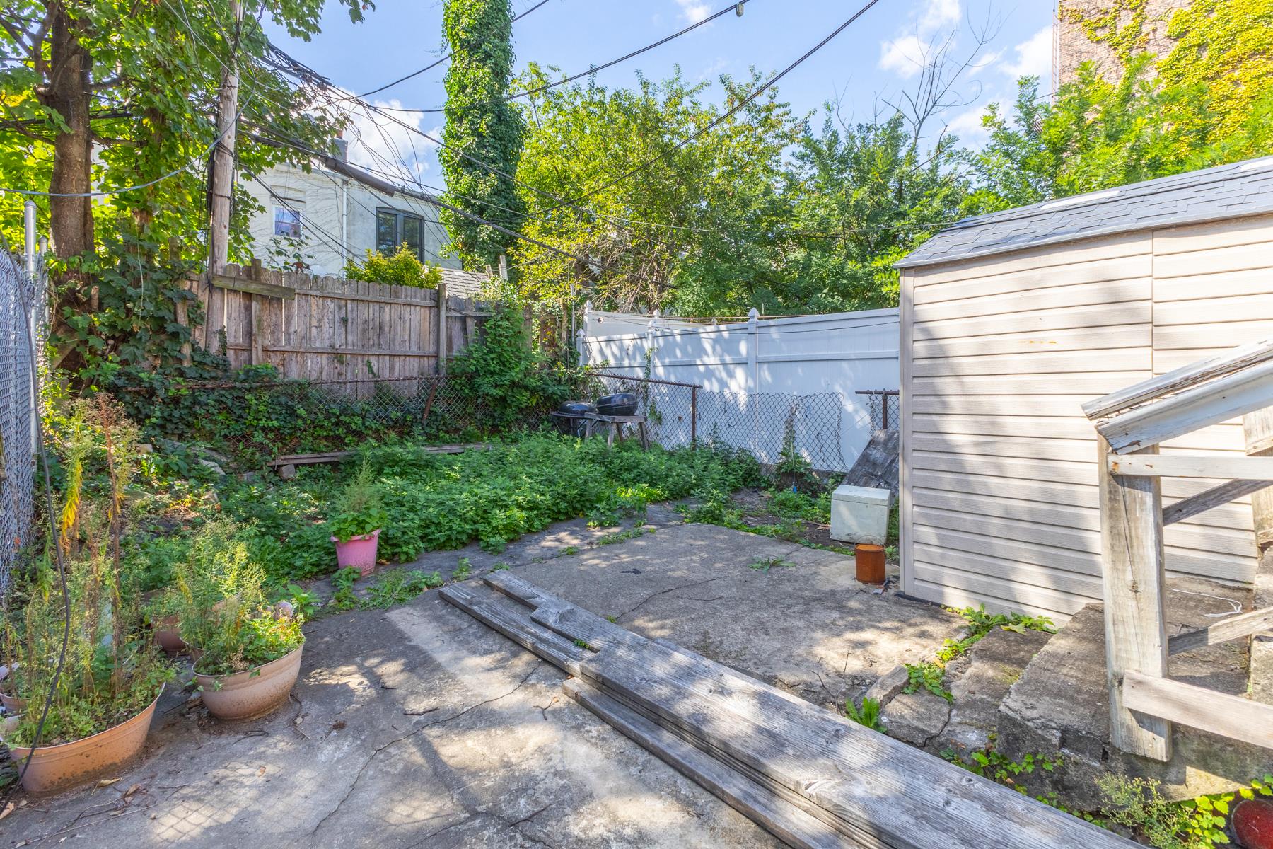 a view of a backyard with potted plants and a fountain