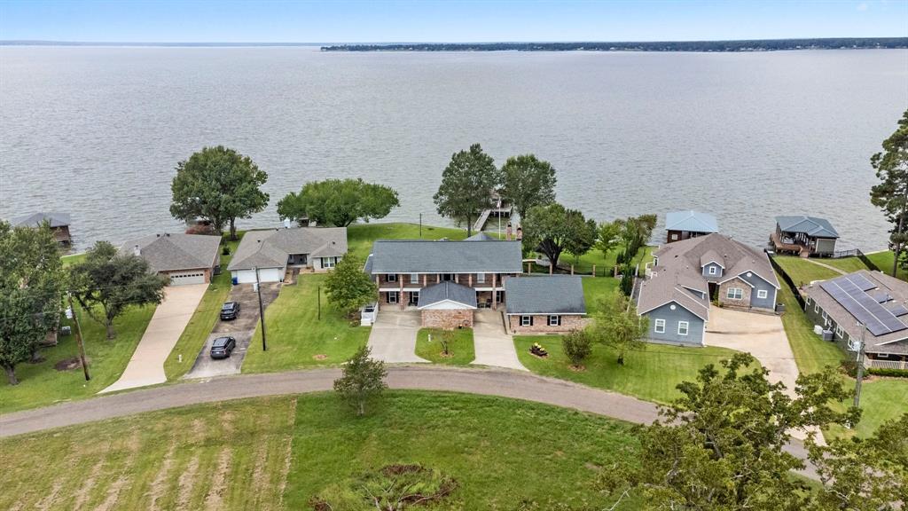 an aerial view of a house with a yard basket ball court