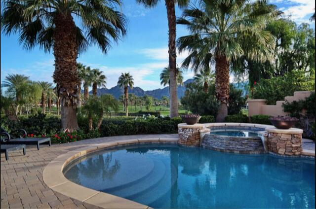 a swimming pool with outdoor seating and plants