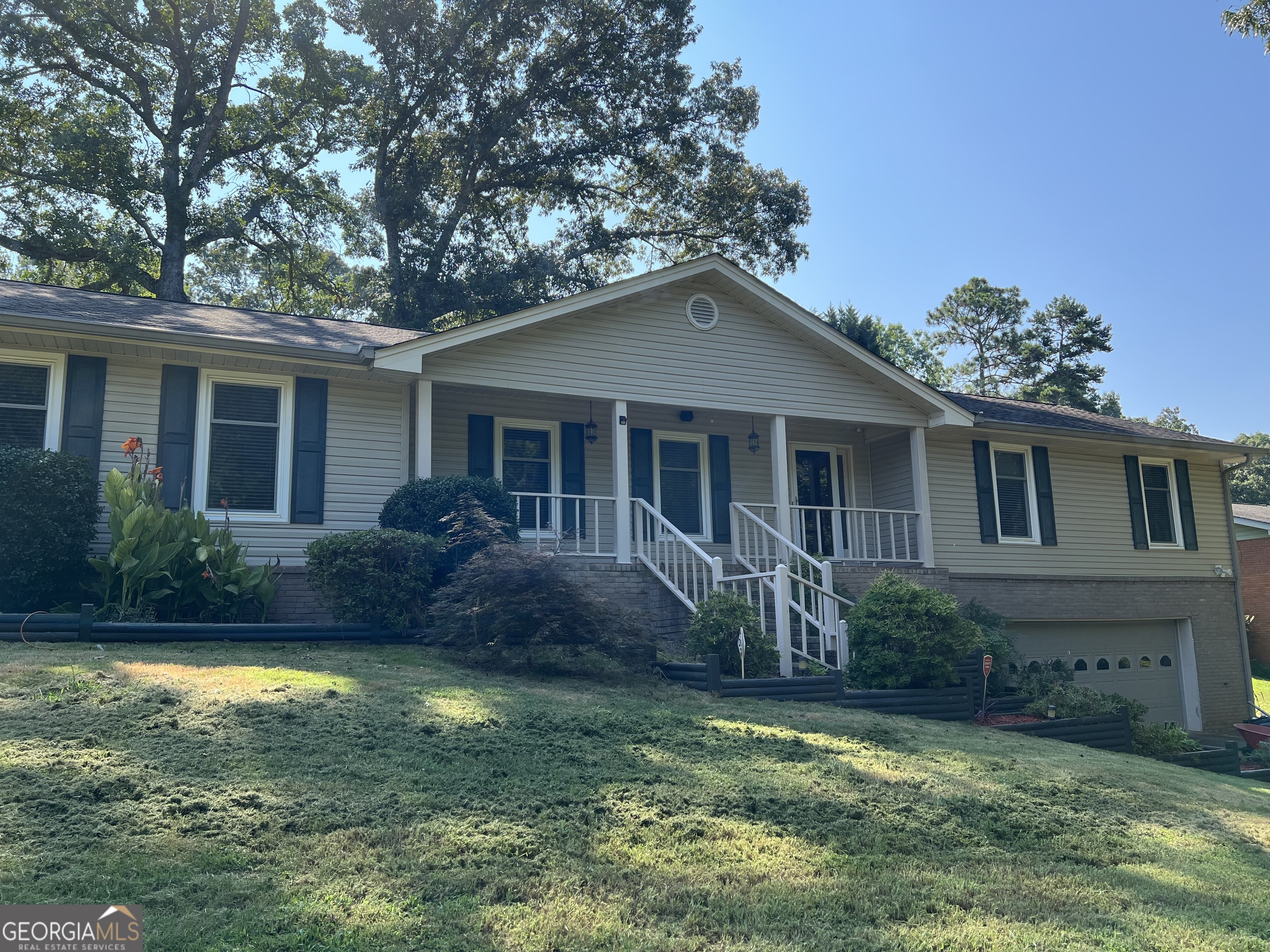 a front view of house with yard and green space