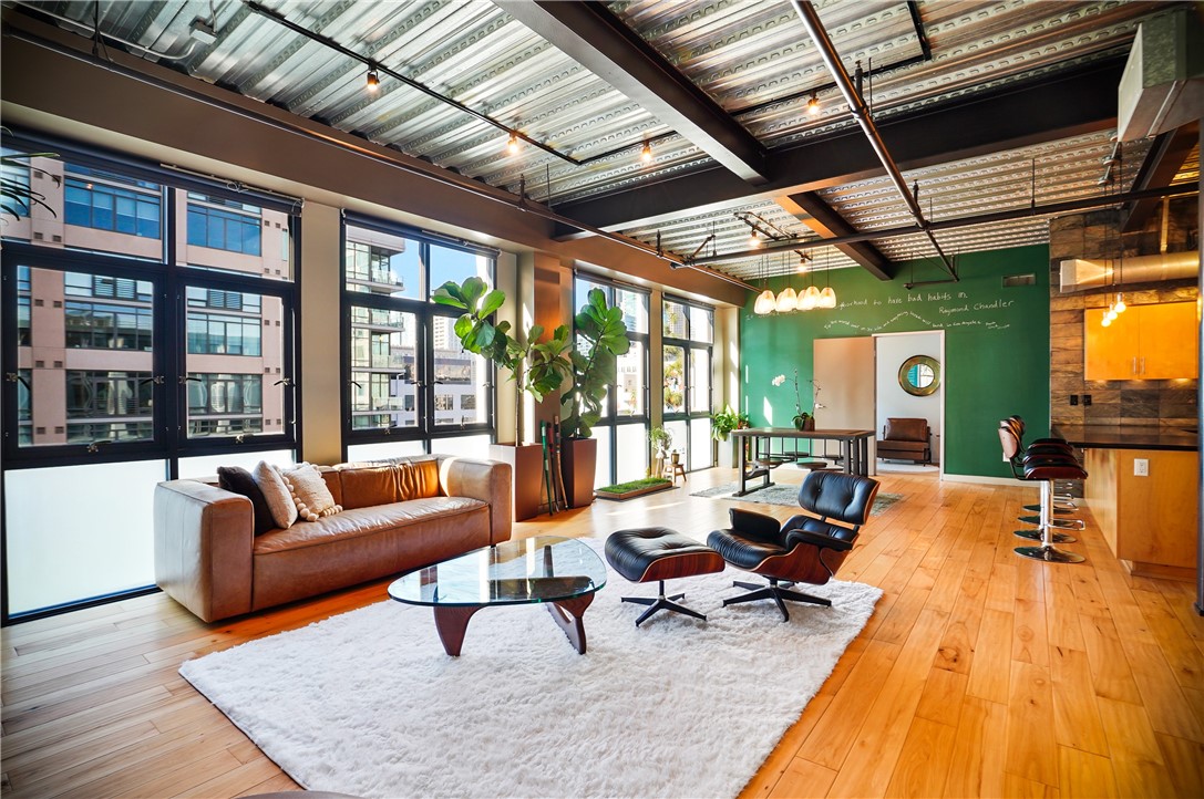 a living room with furniture rug and a large window