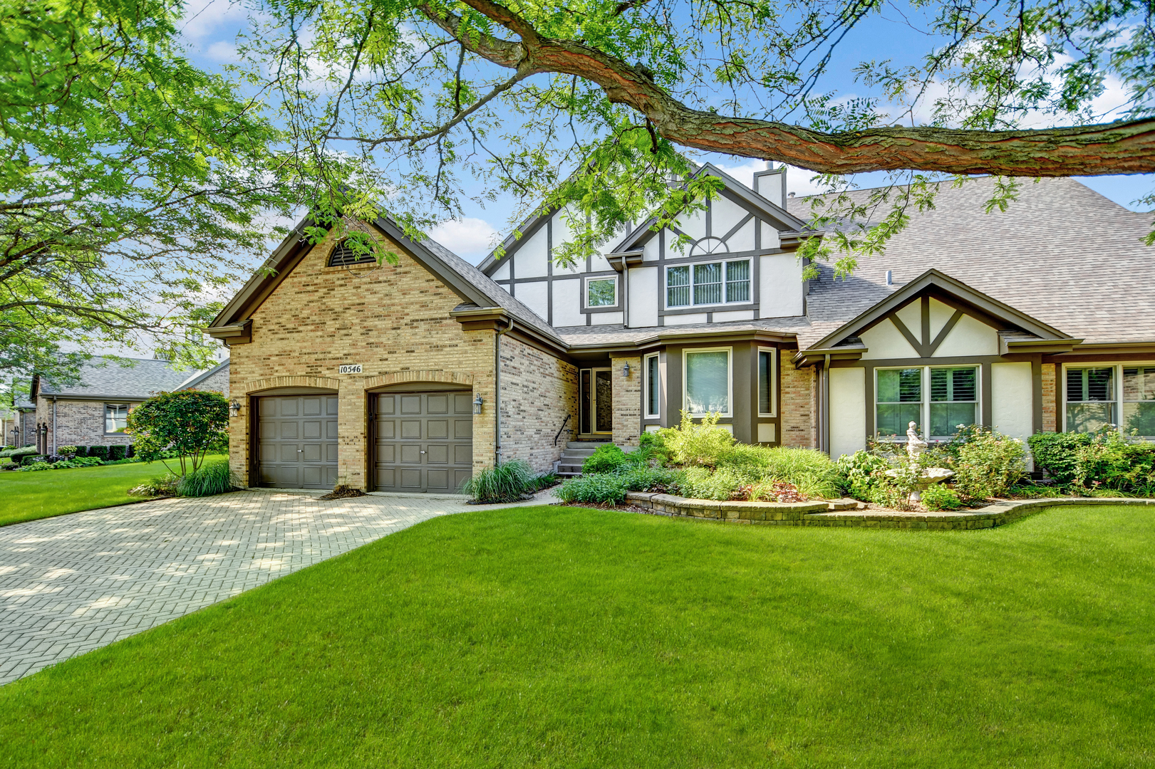 a front view of a house with a yard and garage