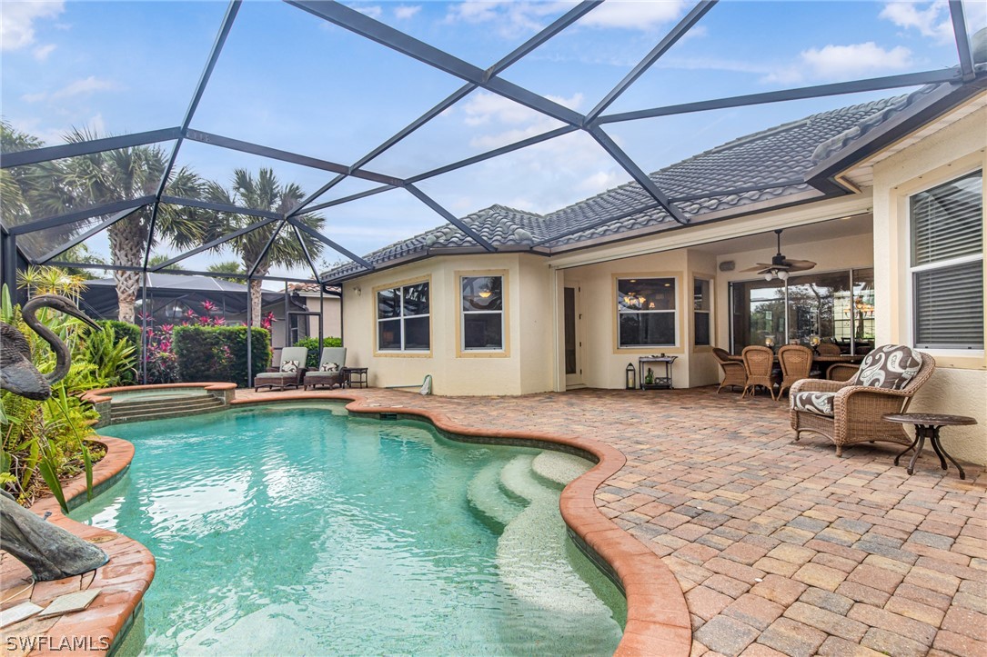 a view of a house with swimming pool and sitting area