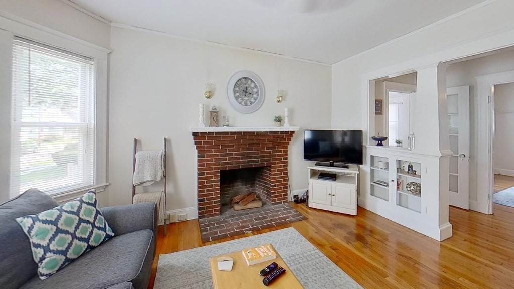 a living room with furniture a flat screen tv and a fireplace