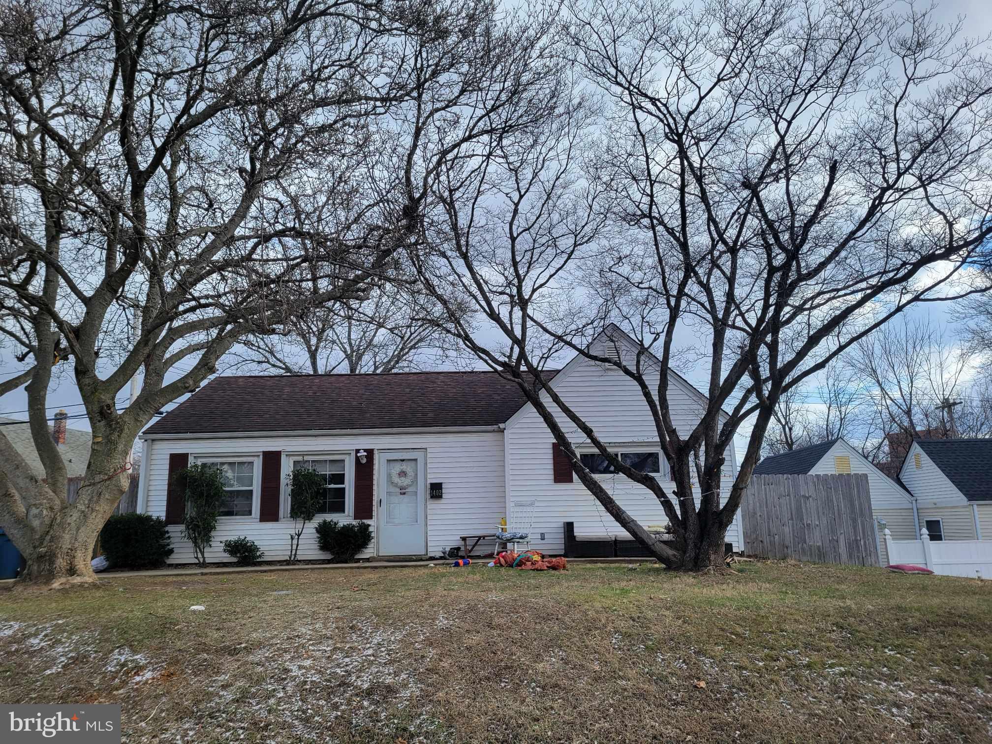 a view of a house with a large tree and a big yard