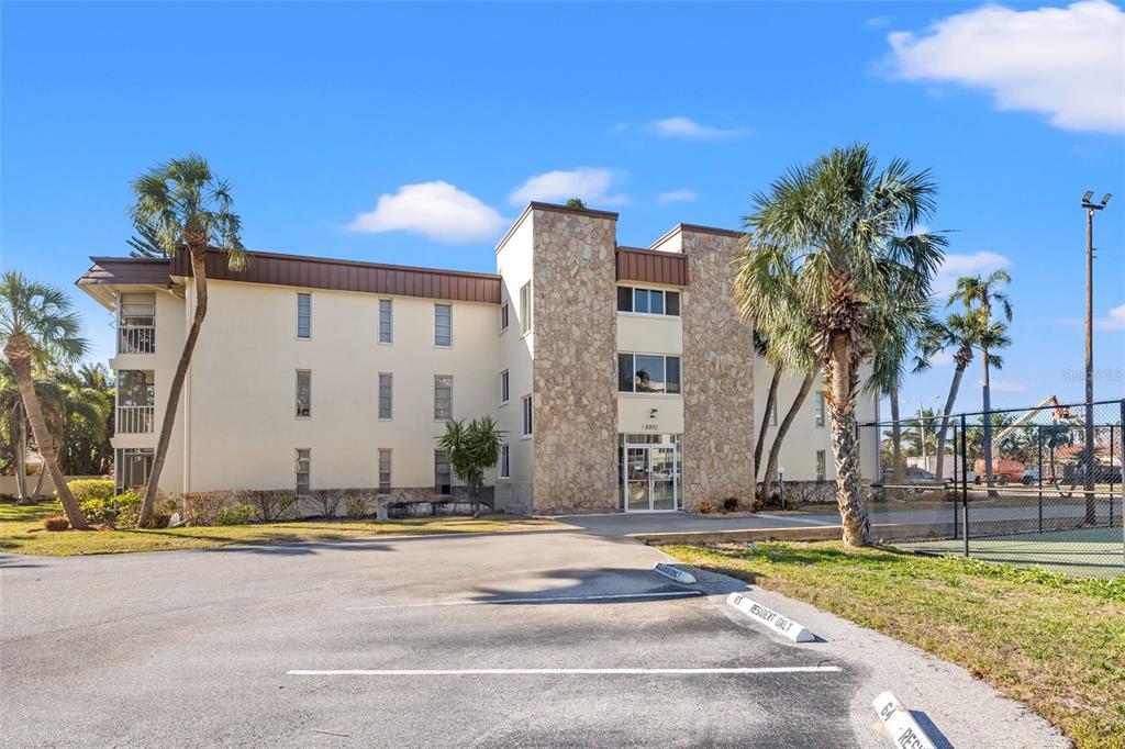 a view of building with palm trees