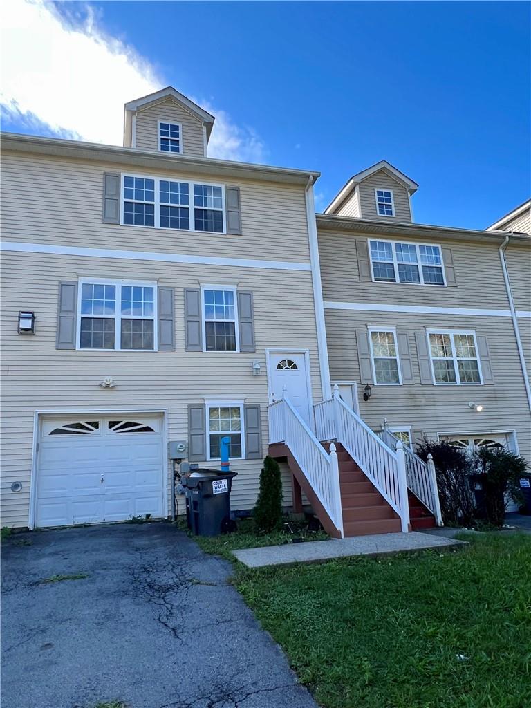 View of front facade featuring a garage