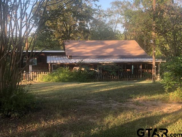 a view of house with backyard