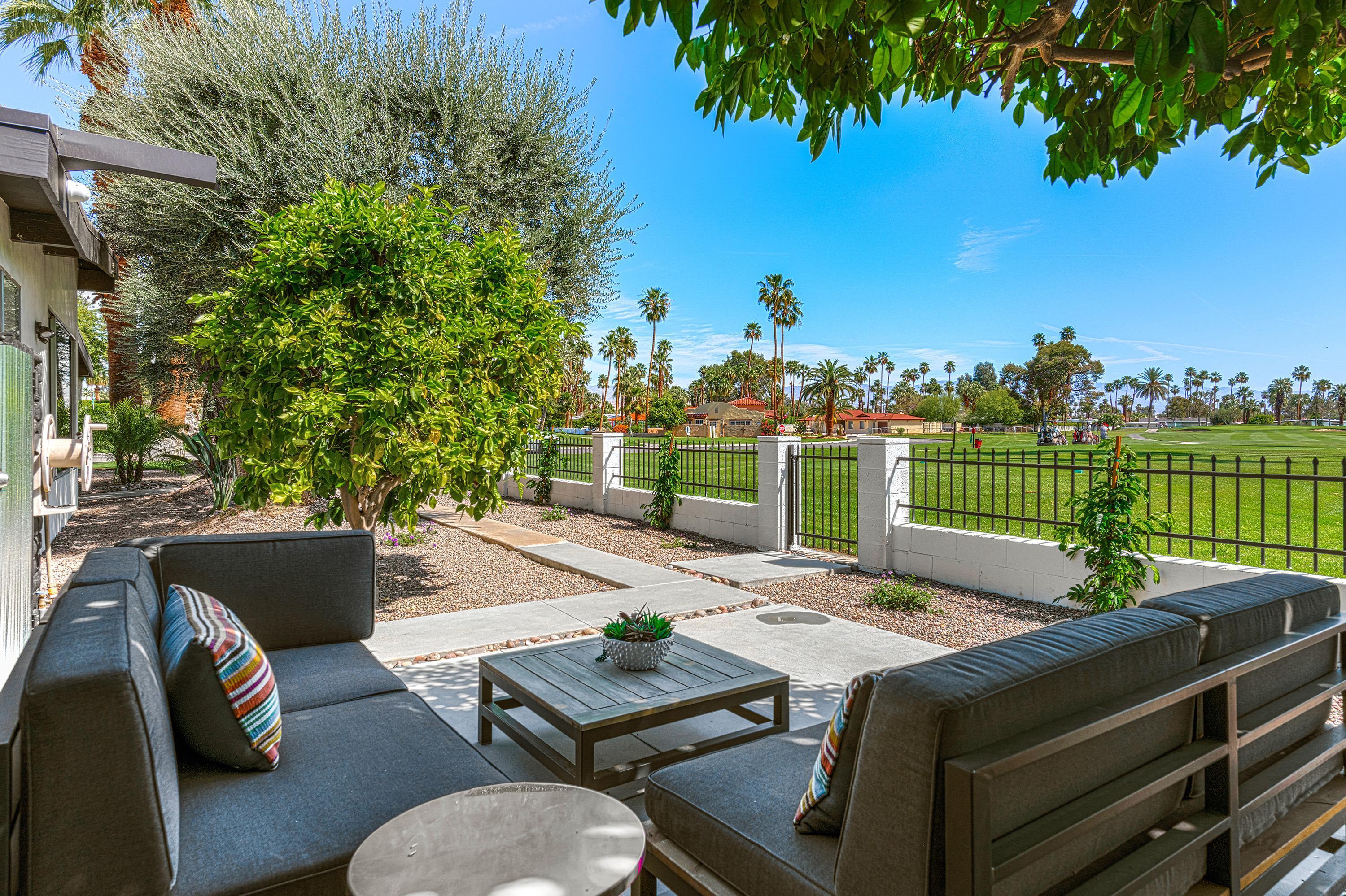 a view of a patio with a table chairs and a table