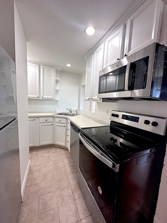 a kitchen with stainless steel appliances and cabinets