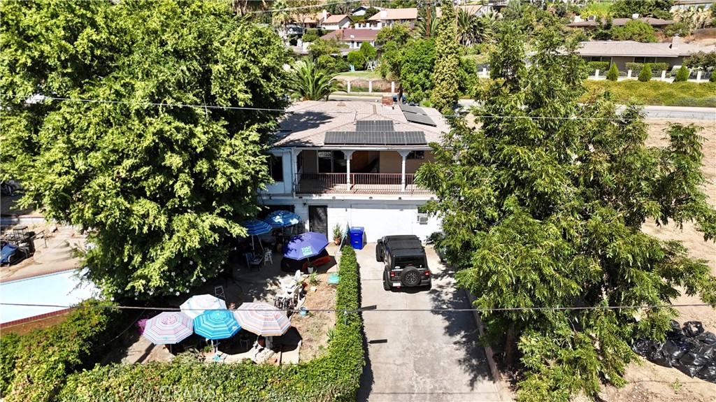 a front view of a house with a yard and fountain